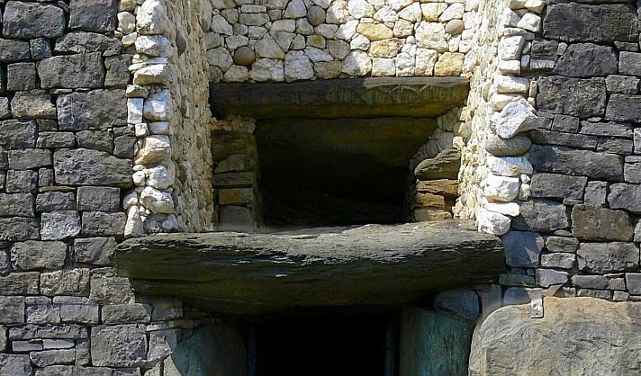Newgrange roofbox with lozenge carvings along the lintel above the entrance opening.