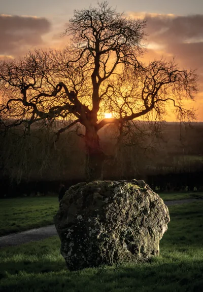 Sunset behind Great Circle stone GC9 at Newgrange, viewed from Kerbstone 18.
